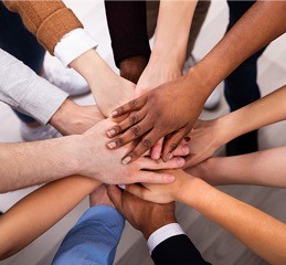 human hands on top of each other in a circle