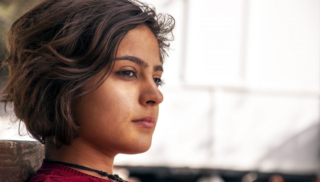 Young woman deep in thought considering Calling Distress Centre of Ottawa and Region